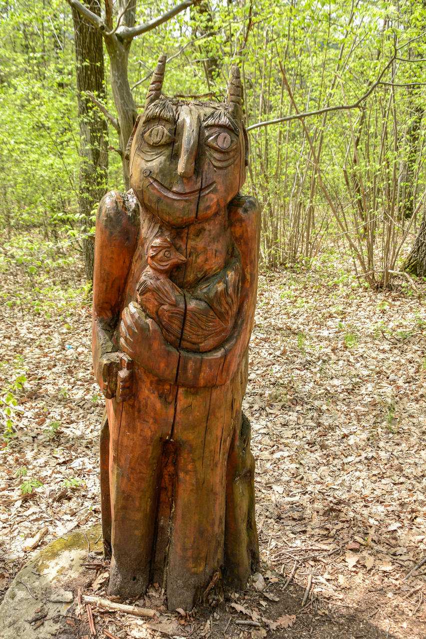 Drewniana figura uśmiechniętego diabełka tuż przy Jaskini Piekło.