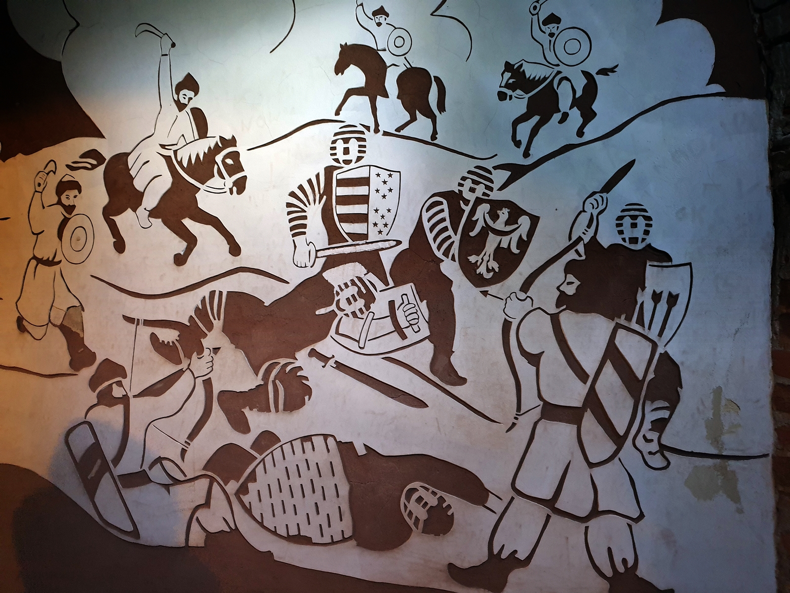 Wykonany specjalną techniką rysunek na ścianie sandomierskich podziemi, nawiązujący do jednej z tutejszych legend.